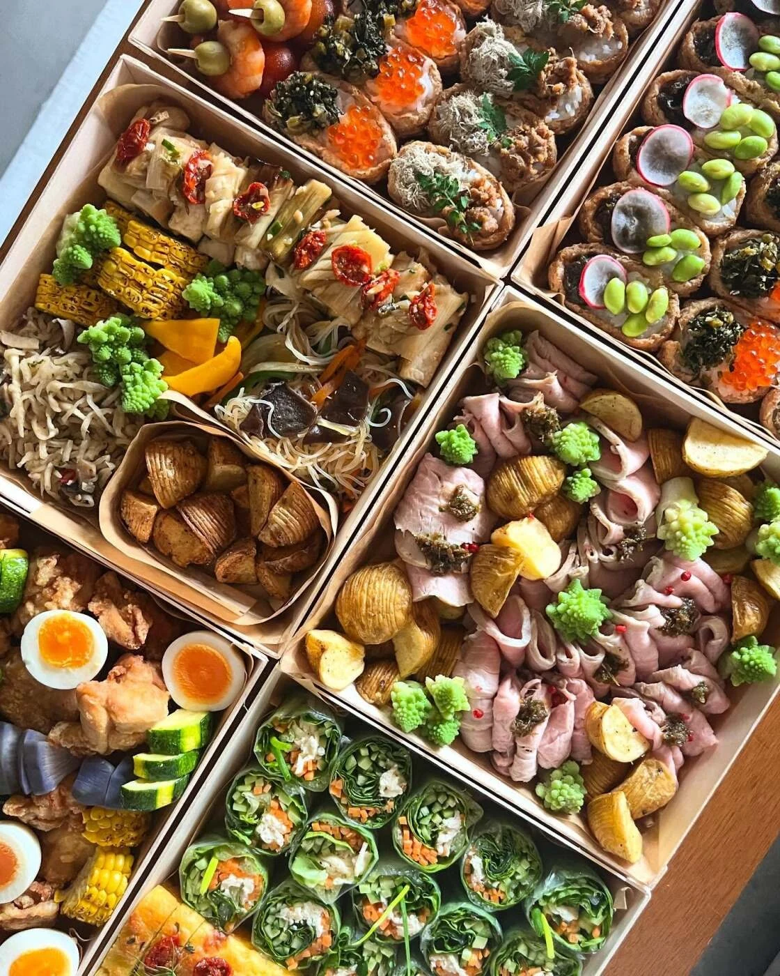 A sharing box filled with seasonal vegetables and prepared dishes